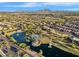 Aerial view showcasing the lake, ramada, walking paths and mountain views at 880 E Wimpole Ave, Gilbert, AZ 85297
