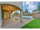 Beautiful backyard featuring a covered patio, pool, and well-manicured lawn at 880 E Wimpole Ave, Gilbert, AZ 85297