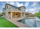 Beautiful backyard featuring a sparkling pool and well-manicured lawn at 880 E Wimpole Ave, Gilbert, AZ 85297