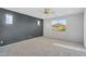 Bright bedroom featuring neutral carpet, large windows and a ceiling fan at 880 E Wimpole Ave, Gilbert, AZ 85297