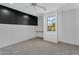 Cozy bedroom features plush carpeting, a ceiling fan, and a custom built-in desk at 880 E Wimpole Ave, Gilbert, AZ 85297