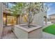 Cozy courtyard with a central water feature, tree, and seamless transition to the indoor living space at 880 E Wimpole Ave, Gilbert, AZ 85297