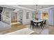 Bright dining room with chandelier, tile floors, and adjacent living area at 880 E Wimpole Ave, Gilbert, AZ 85297