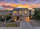 Stunning two-story home featuring lush landscaping, a paver driveway and a covered front entryway at 880 E Wimpole Ave, Gilbert, AZ 85297