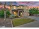 Charming two-story home showcasing well-manicured landscaping and inviting stone accents at 880 E Wimpole Ave, Gilbert, AZ 85297