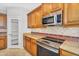 Elegant kitchen featuring granite countertops, tiled backsplash, modern appliances, and ample cabinet space at 880 E Wimpole Ave, Gilbert, AZ 85297