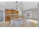 Kitchen featuring a peninsula island, granite countertops, and ample cabinets at 880 E Wimpole Ave, Gilbert, AZ 85297