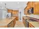Gourmet kitchen showcasing stainless steel appliances, tiled backsplash, and granite countertops, perfect for culinary enthusiasts at 880 E Wimpole Ave, Gilbert, AZ 85297