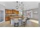 Open-concept kitchen with granite countertops and dine-in bar area at 880 E Wimpole Ave, Gilbert, AZ 85297
