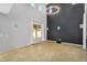 Living room with high ceilings, window, and dark accent wall at 880 E Wimpole Ave, Gilbert, AZ 85297