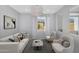 Stylishly furnished living room features modern furniture and ample natural light at 880 E Wimpole Ave, Gilbert, AZ 85297