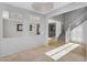 Open-concept living area with tile flooring, staircase, and access to the outdoors at 880 E Wimpole Ave, Gilbert, AZ 85297