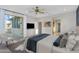 Comfortable bedroom with a ceiling fan, patio access, and neutral paint, perfect for relaxation and unwinding at 880 E Wimpole Ave, Gilbert, AZ 85297