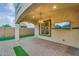 Covered outdoor patio with lighting and television, perfect for entertaining at 880 E Wimpole Ave, Gilbert, AZ 85297