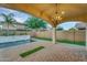 Covered patio with brick pavers and a view of the pool at 880 E Wimpole Ave, Gilbert, AZ 85297
