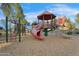 Community playground featuring multiple slides, climbing structures, and a shaded, multi-tiered play area at 880 E Wimpole Ave, Gilbert, AZ 85297