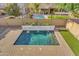 Custom pool with water features, surrounded by green turf, and brick pavers at 880 E Wimpole Ave, Gilbert, AZ 85297