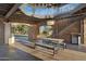 Covered outdoor space with stone accents, metal stairs, and picnic tables offers a unique gathering spot at 880 E Wimpole Ave, Gilbert, AZ 85297