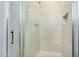 Modern shower featuring glass door and tiled surround with built in niche at 880 E Wimpole Ave, Gilbert, AZ 85297