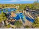 Overhead shot of a vibrant splash pad and playground area, with water features and landscaping at 880 E Wimpole Ave, Gilbert, AZ 85297