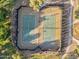 Overhead view of community tennis courts in a landscaped setting, with players visible at 880 E Wimpole Ave, Gilbert, AZ 85297