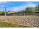 Community sand volleyball court near well-maintained lawns, landscaping, and residential homes at 880 E Wimpole Ave, Gilbert, AZ 85297