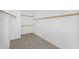 Walk-in closet featuring carpet, shelving, and ample storage space at 880 E Wimpole Ave, Gilbert, AZ 85297