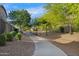 Community walking path with mature trees and greenery that offers residents a scenic route at 880 E Wimpole Ave, Gilbert, AZ 85297