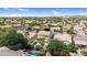 This aerial view showcases a home with a private pool and covered patio in a lush community at 9225 E Pine Valley Rd, Scottsdale, AZ 85260
