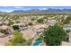 This aerial view showcases a home with a private pool in a lush community with mountain views at 9225 E Pine Valley Rd, Scottsdale, AZ 85260