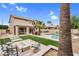 Resort-style backyard featuring a pool, lush landscaping, built-in firepit and outdoor seating area perfect for entertaining at 9225 E Pine Valley Rd, Scottsdale, AZ 85260