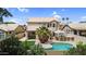Inviting backyard featuring a pool, outdoor kitchen, covered patio, and manicured landscaping, perfect for entertaining at 9225 E Pine Valley Rd, Scottsdale, AZ 85260