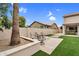 Spacious backyard area featuring a cozy fire pit, artificial grass, and desert landscaping at 9225 E Pine Valley Rd, Scottsdale, AZ 85260
