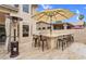 Large outdoor bar area featuring ample seating, a counter, and a nearby heating lamp at 9225 E Pine Valley Rd, Scottsdale, AZ 85260