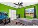 Bright green bedroom features a television, mini-fridge, and a large window with natural light and views at 9225 E Pine Valley Rd, Scottsdale, AZ 85260