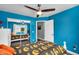 Bright blue bedroom with ceiling fan, mirrored closet doors, and ensuite access is ideal for relaxing or working from home at 9225 E Pine Valley Rd, Scottsdale, AZ 85260