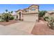 Charming two-story home featuring an attached two-car garage and desert landscaping at 9225 E Pine Valley Rd, Scottsdale, AZ 85260