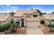 Well-maintained two-story home with tile roof, arched entryway, and desert landscaping in the front yard at 9225 E Pine Valley Rd, Scottsdale, AZ 85260