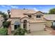 Charming two-story home with a well-manicured front yard, tile roof, and a two car garage at 9225 E Pine Valley Rd, Scottsdale, AZ 85260