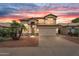 Inviting two-story home featuring a tile roof, desert landscaping, and a two car garage at 9225 E Pine Valley Rd, Scottsdale, AZ 85260
