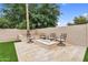 Relaxing backyard area with a built-in fire pit, artificial grass, and desert landscaping at 9225 E Pine Valley Rd, Scottsdale, AZ 85260