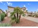 Charming two-story home features a red-rock front yard with beautiful desert landscaping and an attached two-car garage at 9225 E Pine Valley Rd, Scottsdale, AZ 85260