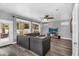 Comfortable living area with a large sofa, a ceiling fan, and access to the backyard patio at 9225 E Pine Valley Rd, Scottsdale, AZ 85260