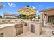 Outdoor kitchen featuring stainless steel grill, countertop bar and dining space, perfect for enjoying outdoor meals at 9225 E Pine Valley Rd, Scottsdale, AZ 85260