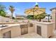 Outdoor kitchen features a stainless steel grill, sink, and storage for backyard cooking and entertaining at 9225 E Pine Valley Rd, Scottsdale, AZ 85260