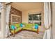 Covered outdoor patio has a cozy lounge area with stylish furniture, perfect for relaxing outdoors at 9225 E Pine Valley Rd, Scottsdale, AZ 85260