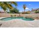 Refreshing backyard pool featuring mature palm trees, a cascading water feature, and patio seating for relaxing poolside at 9225 E Pine Valley Rd, Scottsdale, AZ 85260