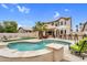 Backyard oasis boasts a sparkling pool, an outdoor bar, and mature landscaping perfect for outdoor enjoyment at 9225 E Pine Valley Rd, Scottsdale, AZ 85260