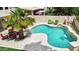 Backyard featuring a refreshing pool with a waterfall feature and lush landscaping at 9225 E Pine Valley Rd, Scottsdale, AZ 85260