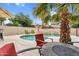Inviting backyard with a refreshing pool, lush landscaping, and a comfortable seating area at 9225 E Pine Valley Rd, Scottsdale, AZ 85260